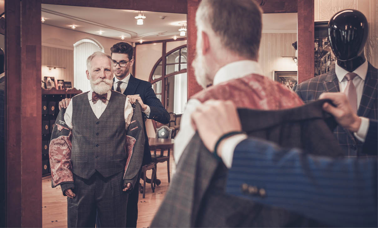 Tailor measuring client for custom made garment