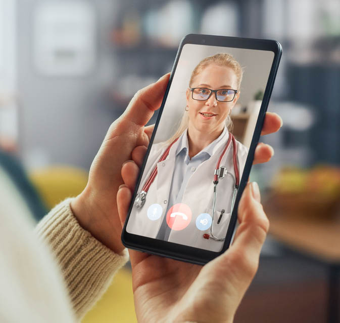 Close Up of a Female Chatting in a Video Call with Her Black Male Family Doctor on Smartphone from Living Room. Ill-Feeling Woman Making a Call from Home with Physician Over the Internet.
